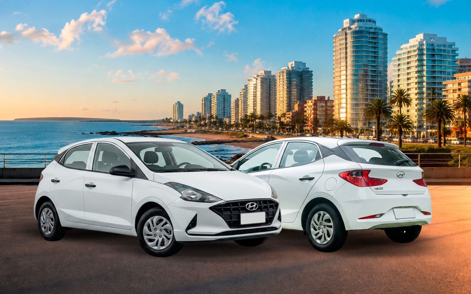 Hyundai HB20 blanco de cinco puertas, de frente y de atrás, con la playa y los edificios de la costa de Montevideo detrás
