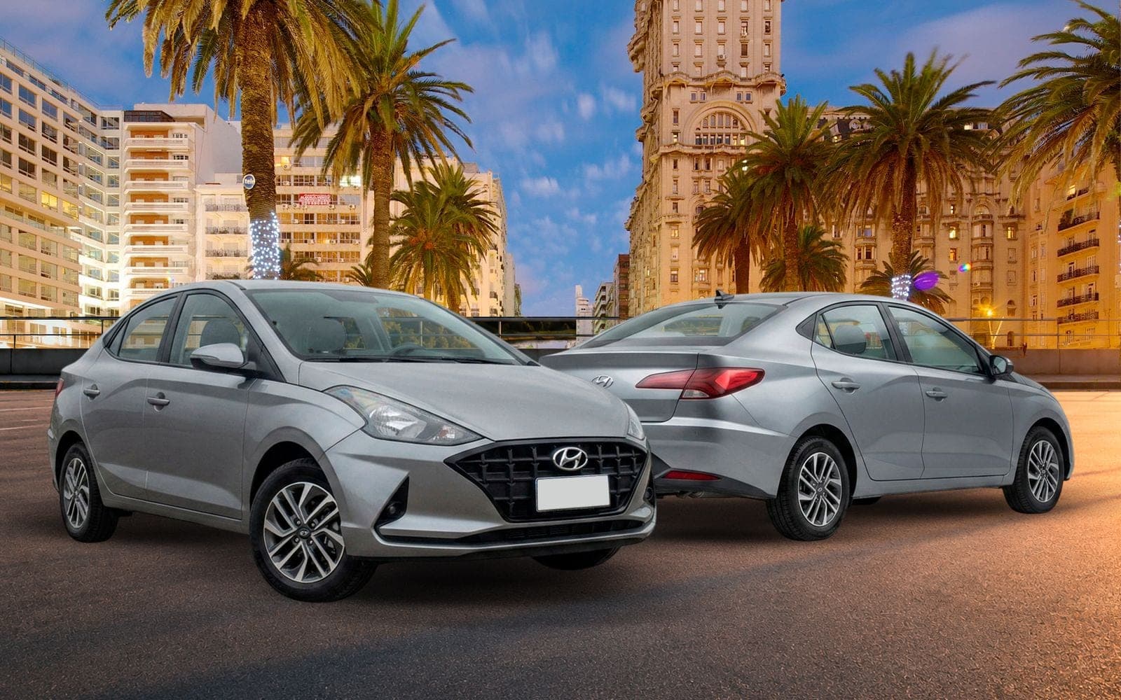 Hyundai HB20s plateado, de frente y de atrás, con el Palacio Salvo y las palmeras de la Plaza Independencia detrás